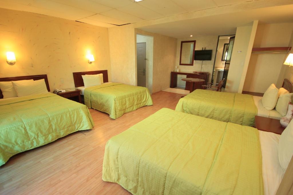 Postel nebo postele na pokoji v ubytování Hotel Enterprise Inn Plaza