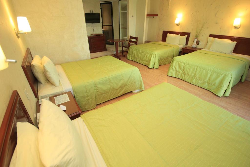 Postel nebo postele na pokoji v ubytování Hotel Enterprise Inn Plaza