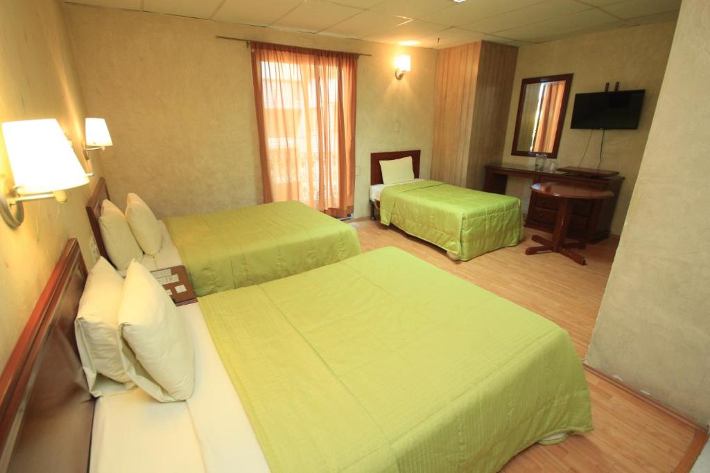 Postel nebo postele na pokoji v ubytování Hotel Enterprise Inn Plaza
