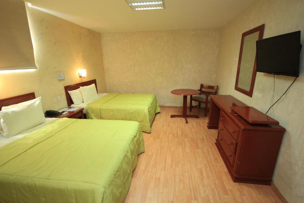 Postel nebo postele na pokoji v ubytování Hotel Enterprise Inn Plaza