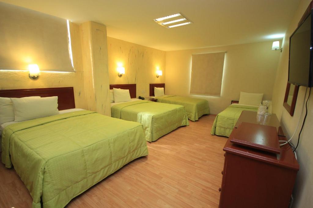 Postel nebo postele na pokoji v ubytování Hotel Enterprise Inn Plaza