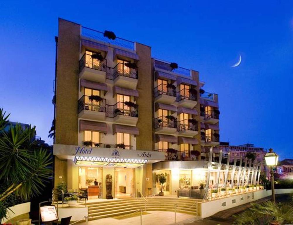 a large building with a moon in the sky at Hotel Aida in Alassio