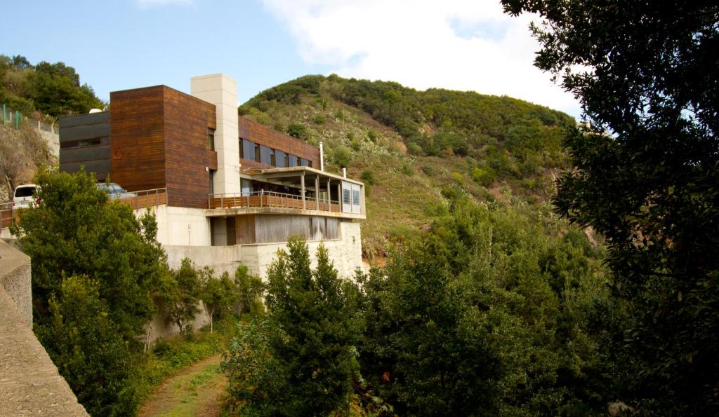 a building on the side of a hill at Albergue Montes de Anaga in El Bailadero