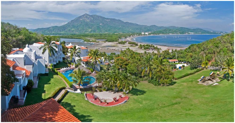 an aerial view of a resort and a beach at Palma Real in Manzanillo