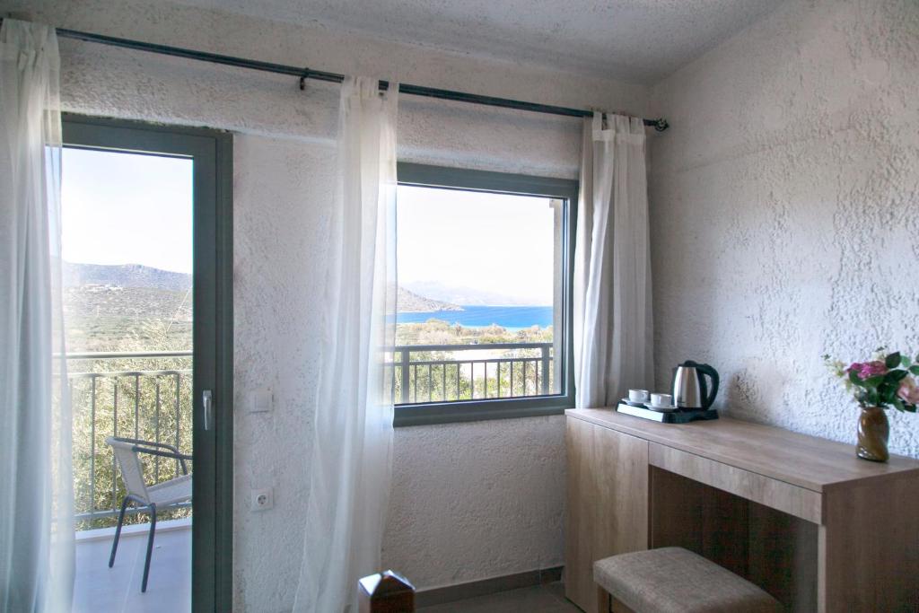 a room with a window with a view of a balcony at Elpida Village in Istro