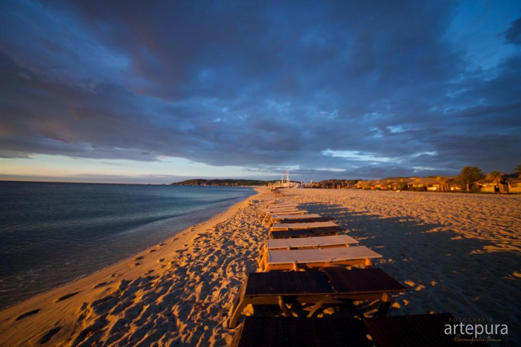 a row of tables on a beach near the water at Sas Robrecht in Saint-Tropez