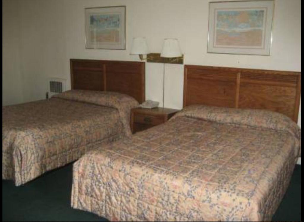 a hotel room with two beds in a room at Arbor Inn Motor Lodge in Wrentham
