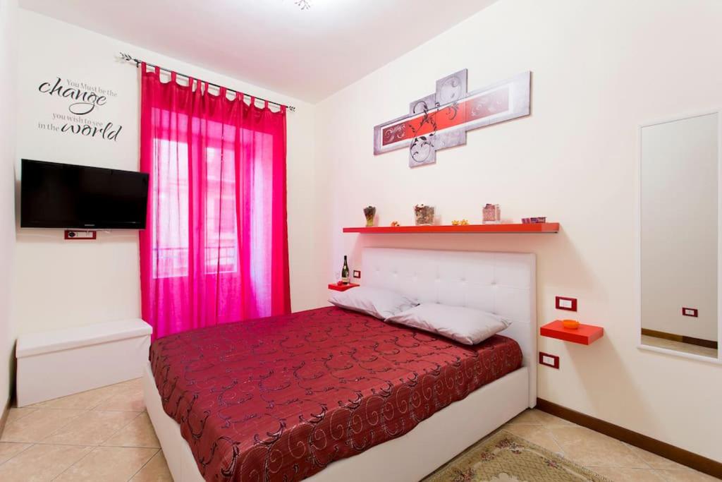 a bedroom with a red bed and a pink window at BB45 in Palermo