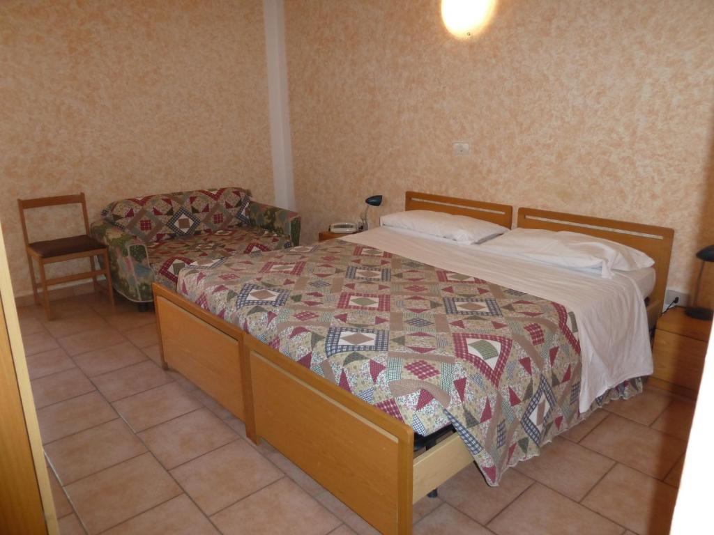 Postel nebo postele na pokoji v ubytování Hotel Bolognese