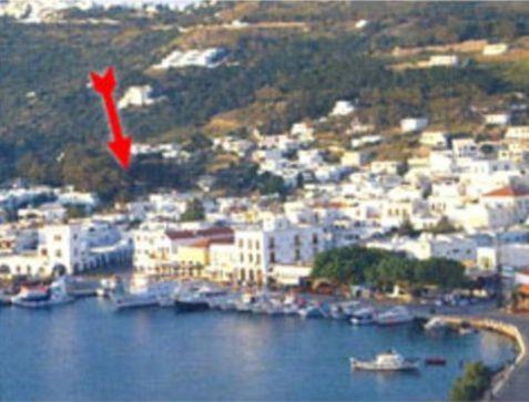 a red kite is flying over a city at Villa Zacharo in Skala