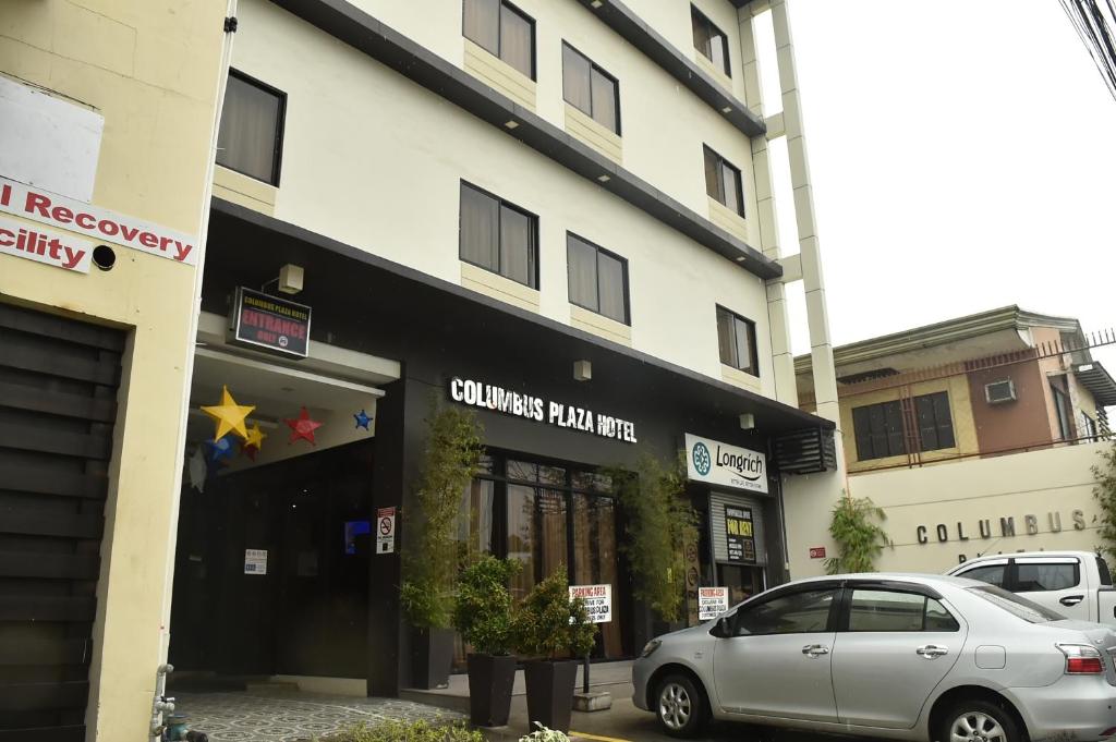 a car parked in front of a building at Columbus Plaza Hotel in General Santos