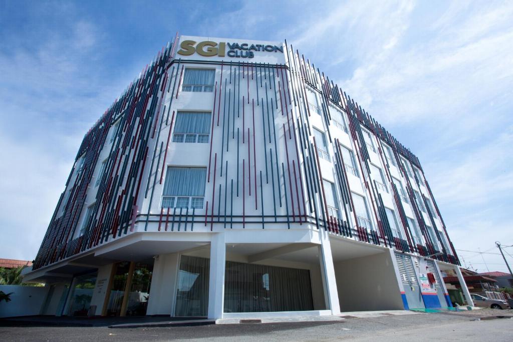 a glass building with a sign on top of it at SGI Vacation Club Hotel in Melaka