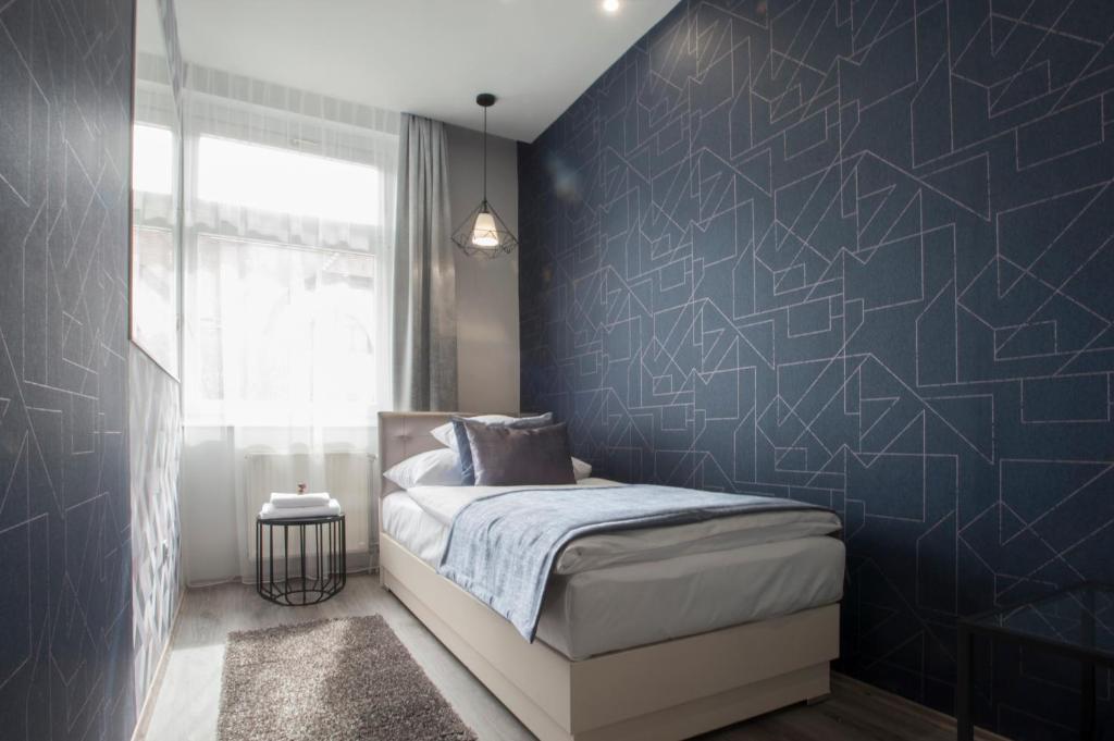 Posteľ alebo postele v izbe v ubytovaní Hotel Talizmán