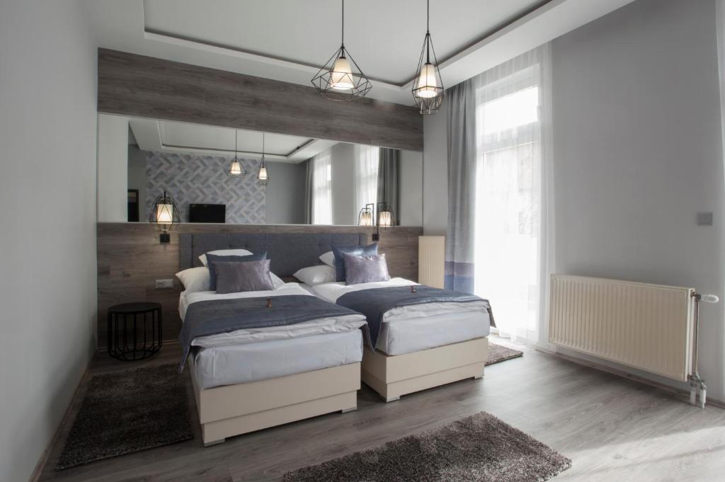 Posteľ alebo postele v izbe v ubytovaní Hotel Talizmán