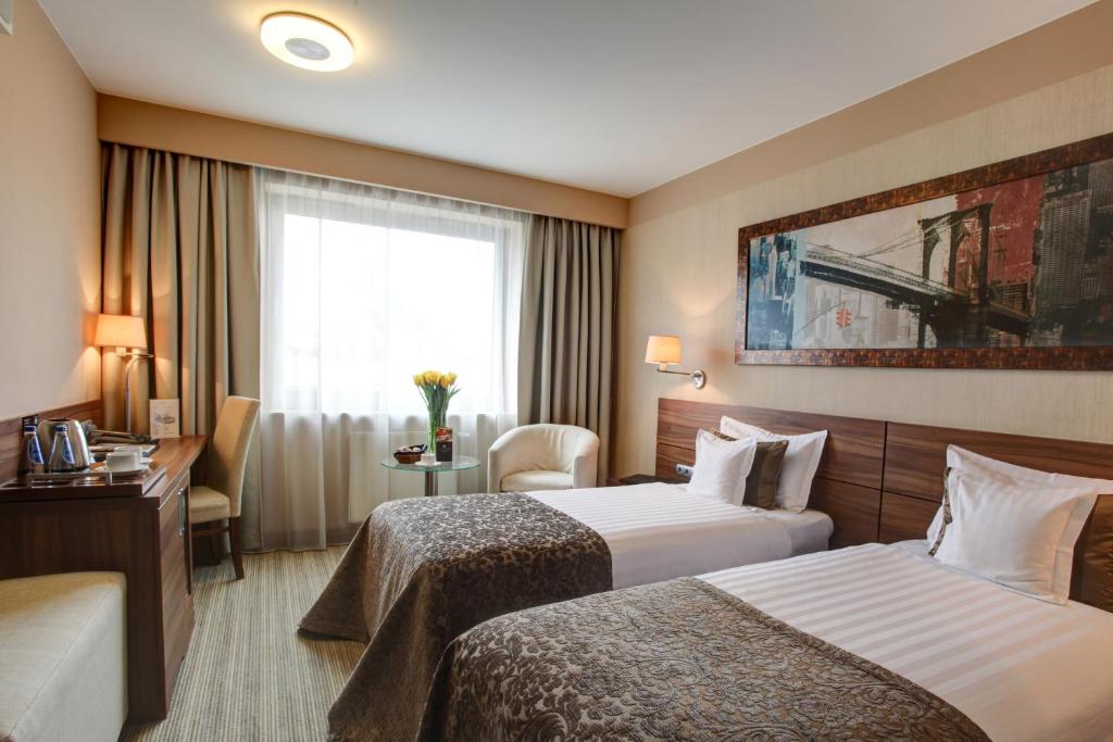 Postel nebo postele na pokoji v ubytování Haston City Hotel