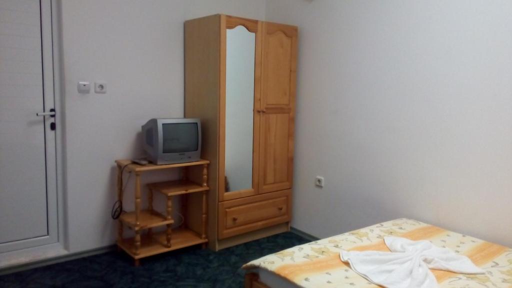 a bedroom with a bed and a tv on a cabinet at Guest House Diamant in Sozopol