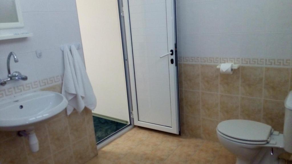 a bathroom with a shower and a toilet and a sink at Guest House Diamant in Sozopol