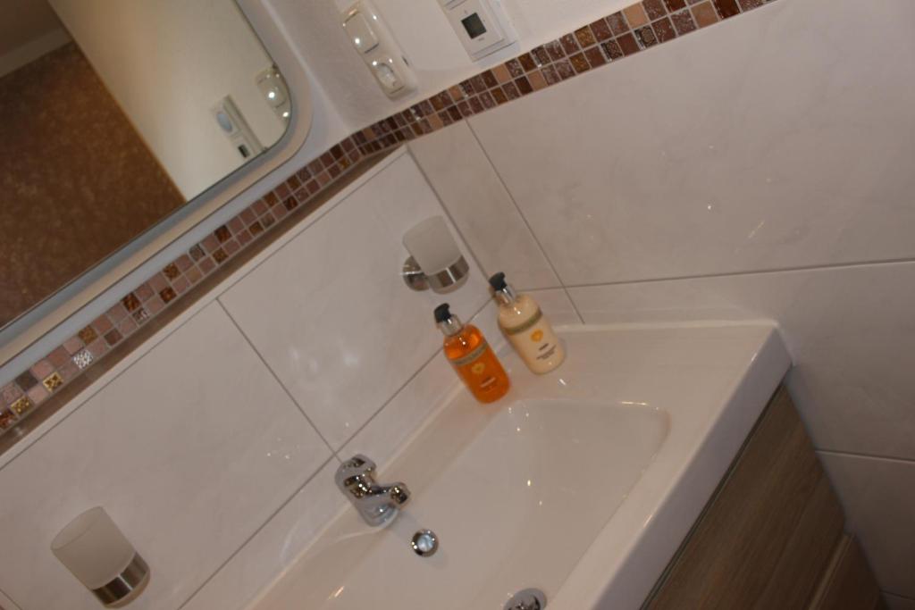 a bathroom with a white sink and a mirror at Ferienhof Bernegglehen in Berchtesgaden