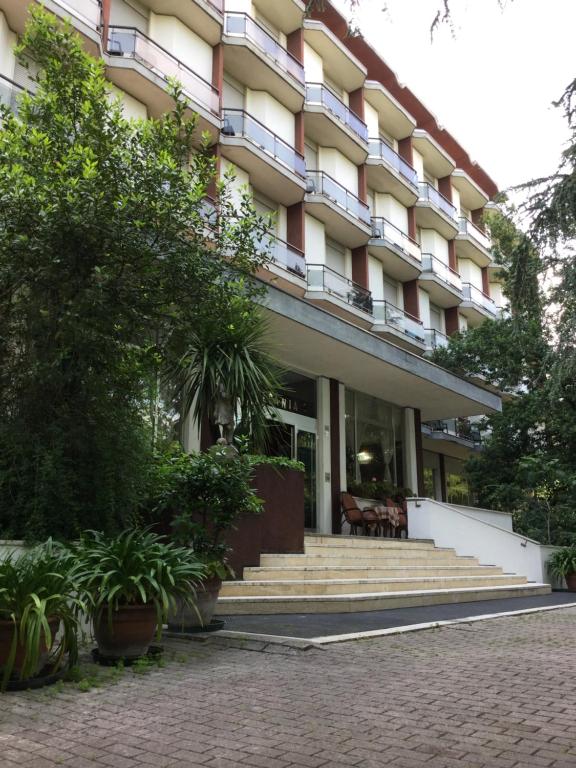 a building with stairs and plants in front of it at Hotel Terme Vulcania in Montegrotto Terme