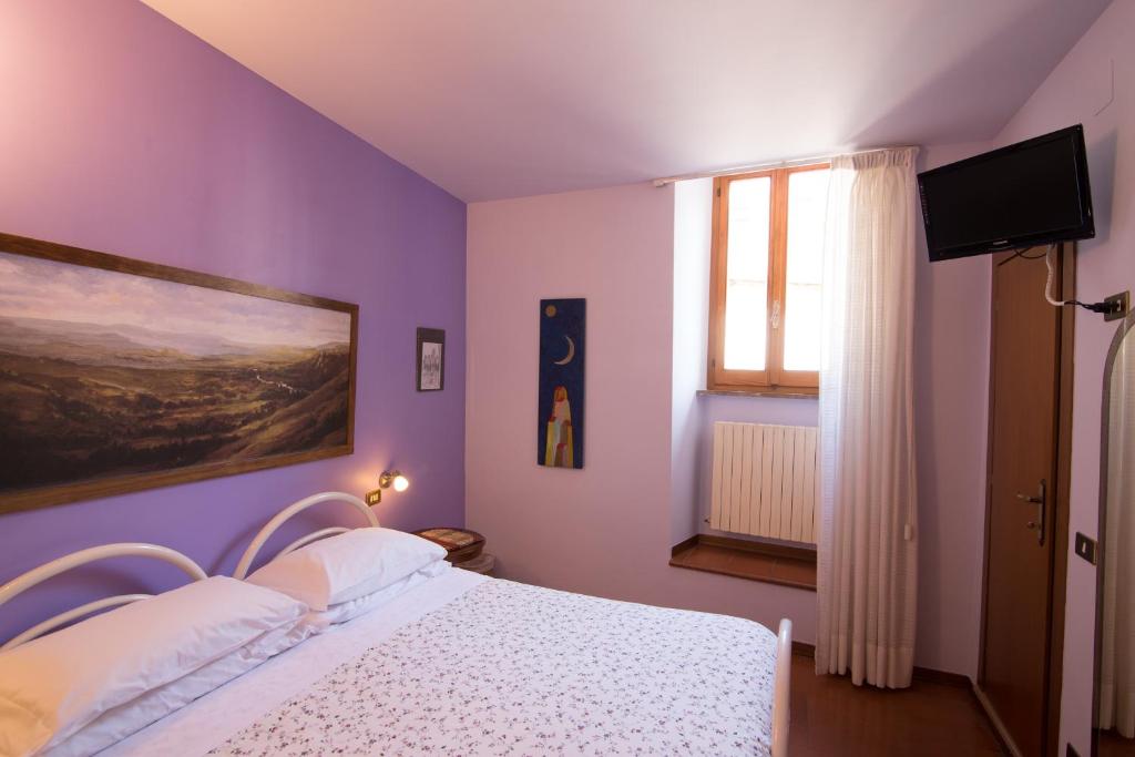 Postel nebo postele na pokoji v ubytování Hotel Pallotta