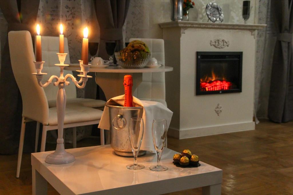 a living room with a table with candles and a fireplace at Barberini Dream in Rome