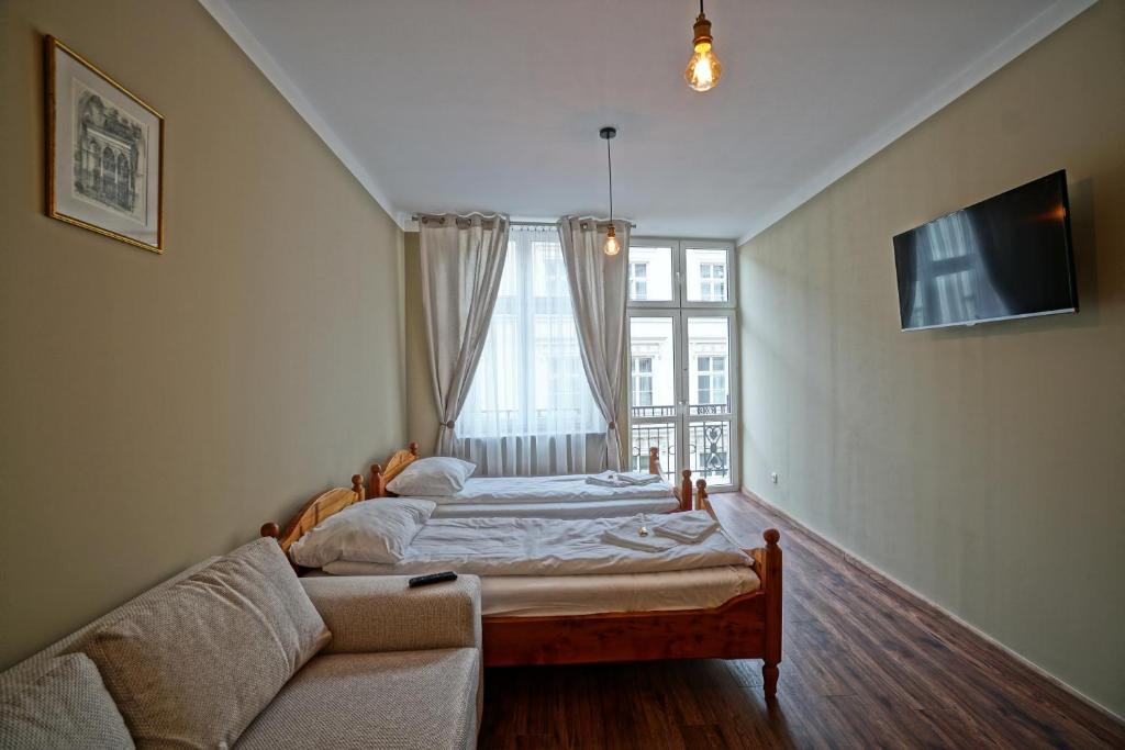 Posteľ alebo postele v izbe v ubytovaní Apartamenty Grodzka 8