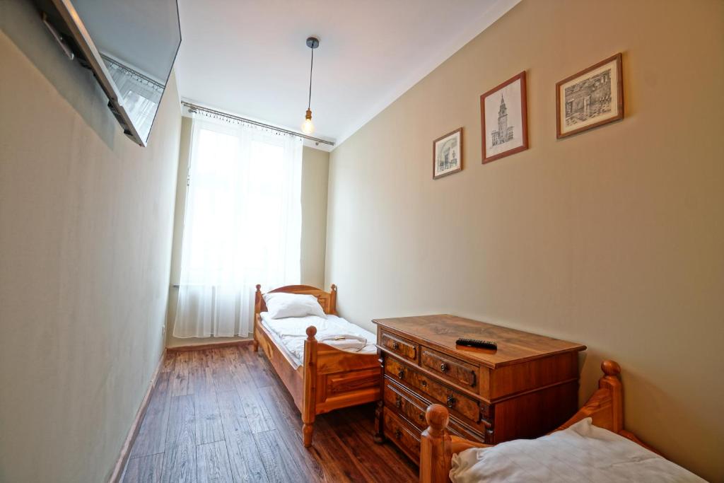 Posteľ alebo postele v izbe v ubytovaní Apartamenty Grodzka 8