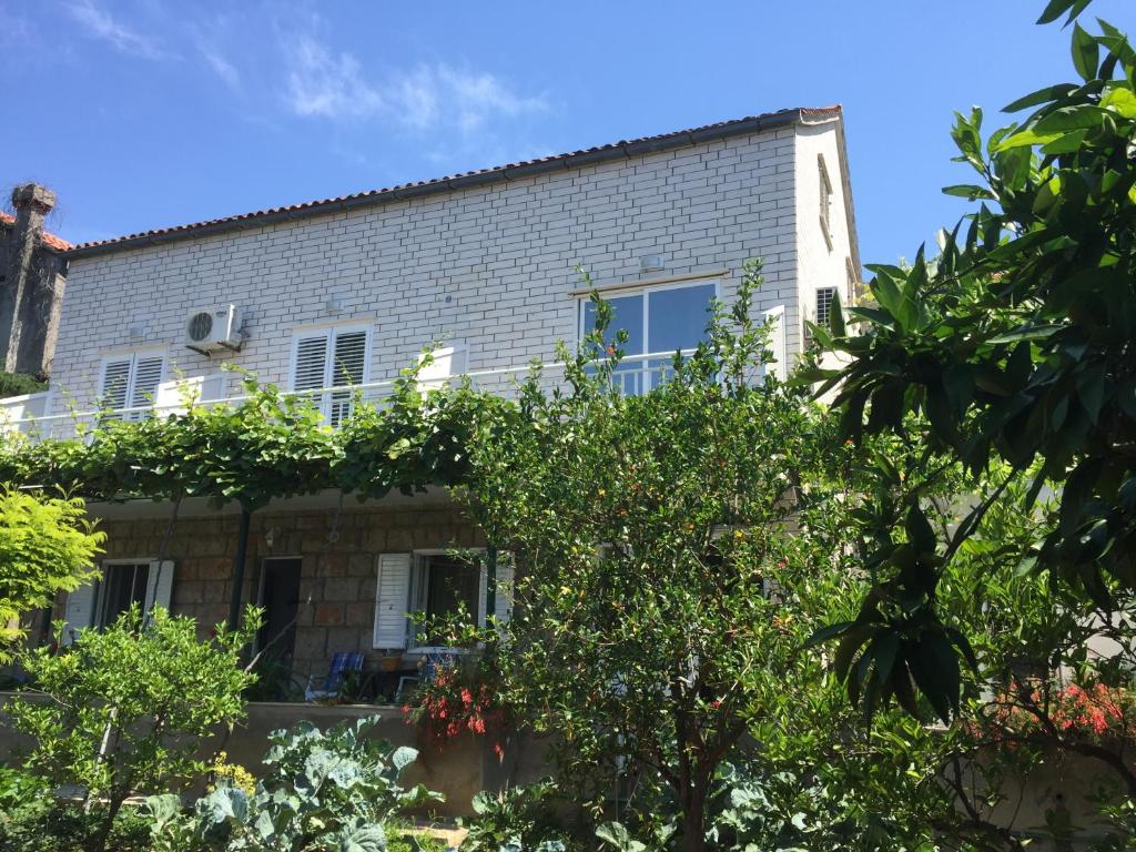 a building with trees in front of it at Jele Rooms in Dubrovnik