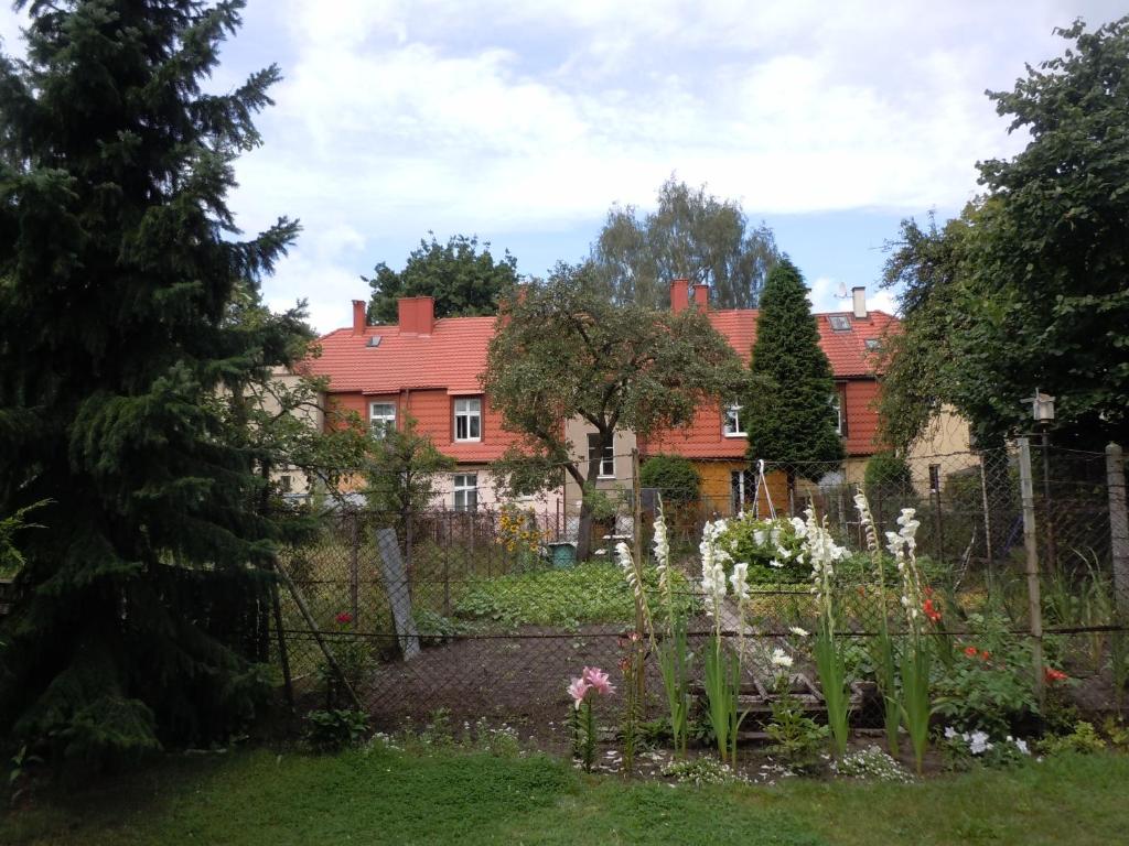 un jardin en face d'une maison avec une clôture dans l'établissement Apt nr 3 - cogito.home - Marina, à Gdańsk