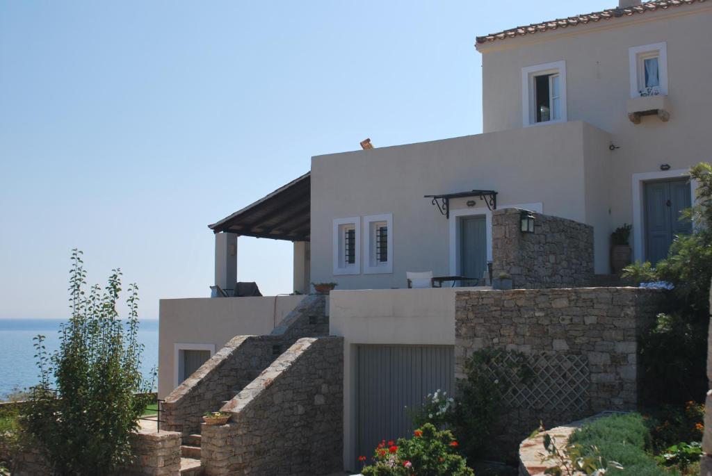 a white house with the ocean in the background at Almyra Kythera in Agia Pelagia