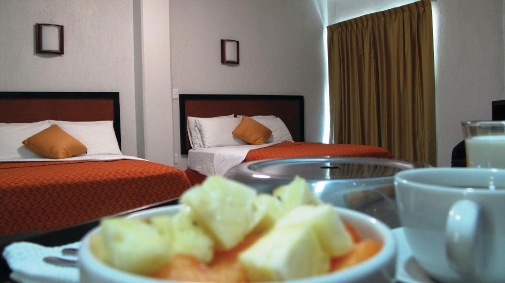 Postel nebo postele na pokoji v ubytování Hotel RS Suites