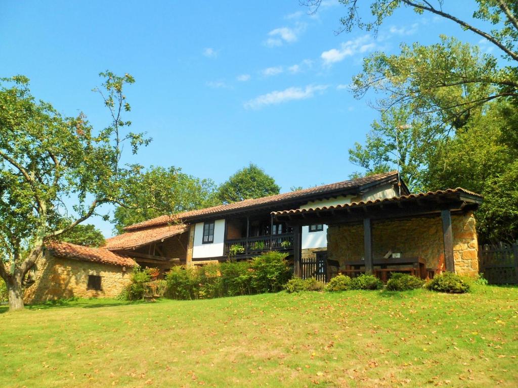 una casa de piedra con un gran patio delante en Casa Rural La Retuerta, en Nava