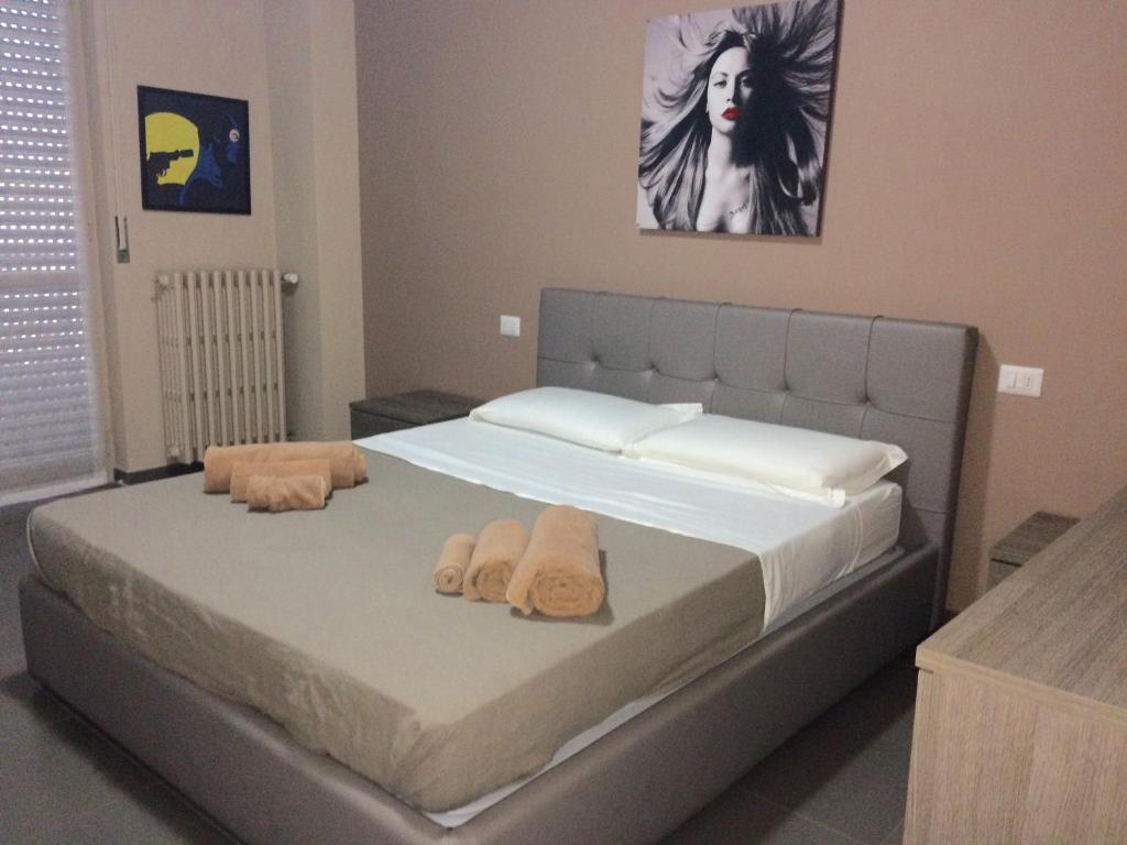 a bedroom with a bed with towels on it at Siag Apartments in Cormano