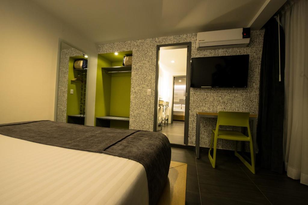 Postel nebo postele na pokoji v ubytování Hotel Perla Central