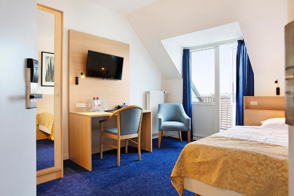 Postel nebo postele na pokoji v ubytování Herning City Hotel