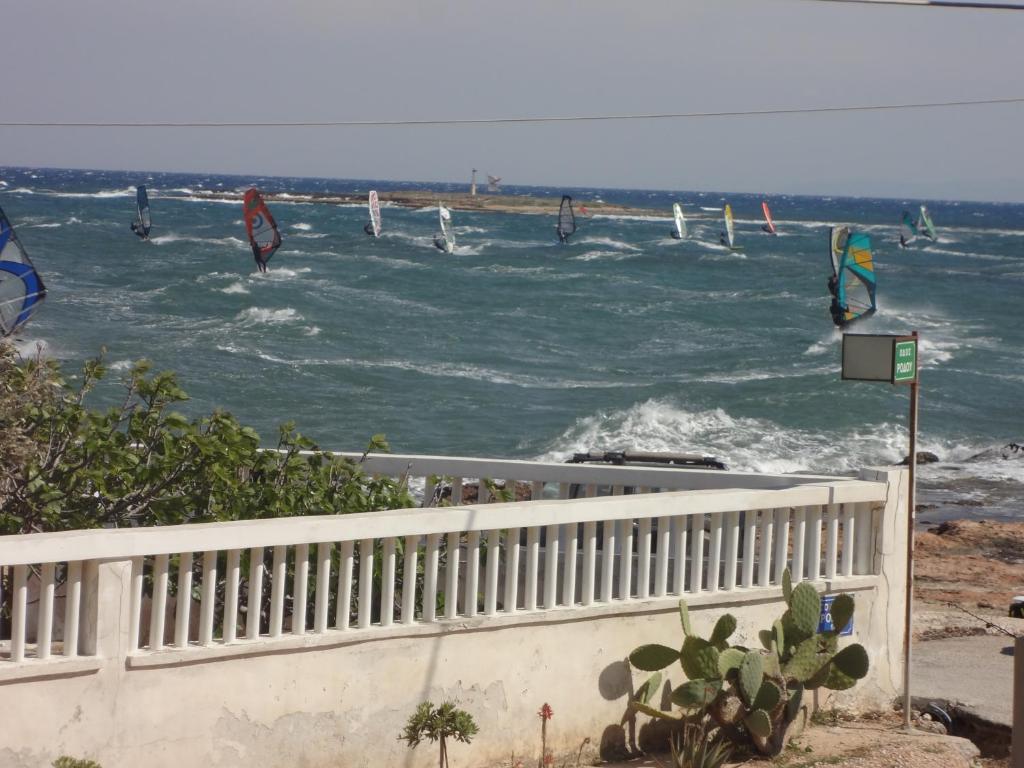 a group of people wind surfing in the ocean at Surf House in Artemida