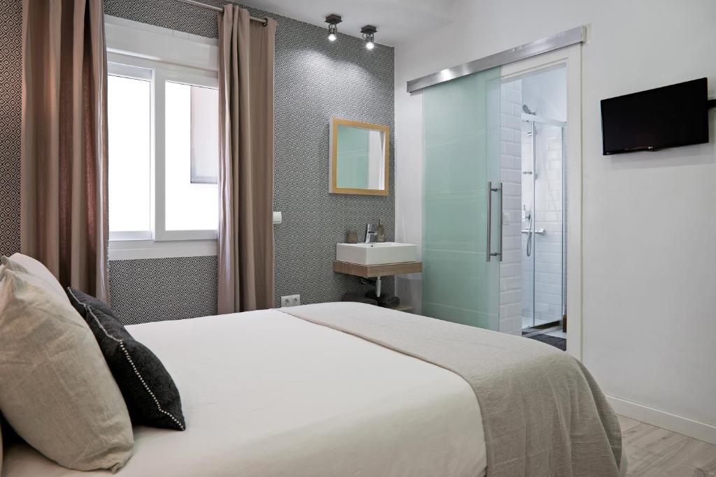 a hotel room with a large bed and a large mirror at Luxury Apartment Picasso in Málaga