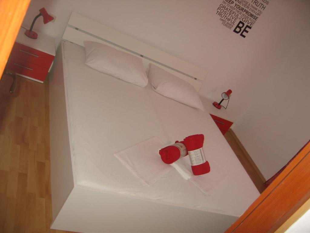 a small white refrigerator with a bottle in it at Nevera Apartments Pašman,Banj in Banj