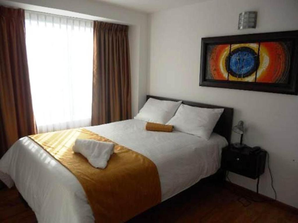 Postel nebo postele na pokoji v ubytování Hotel Expo Inn Embajada