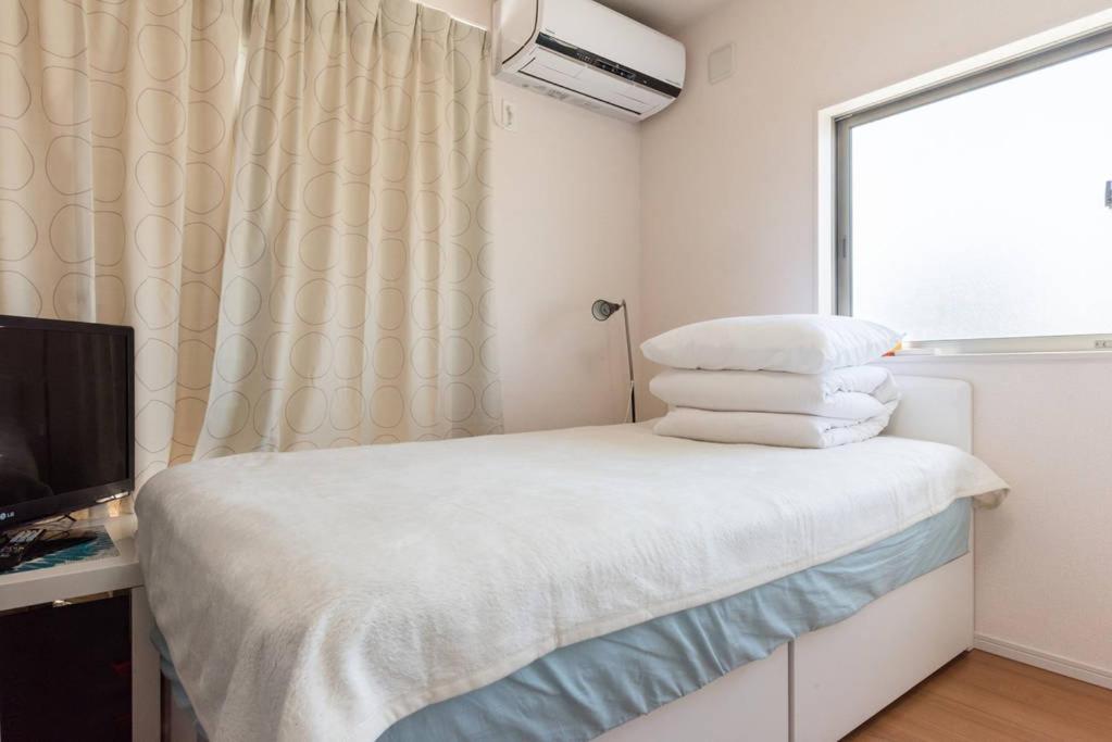 Postel nebo postele na pokoji v ubytování Hinode House