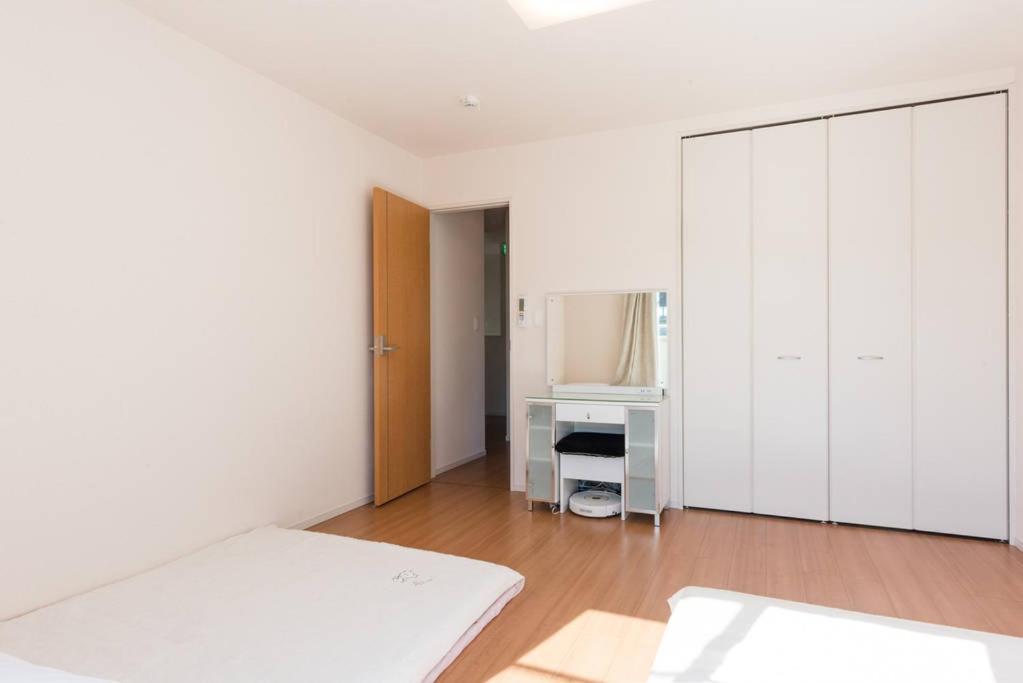Postel nebo postele na pokoji v ubytování Hinode House