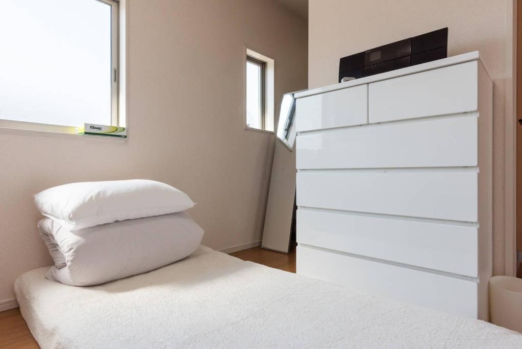Postel nebo postele na pokoji v ubytování Hinode House
