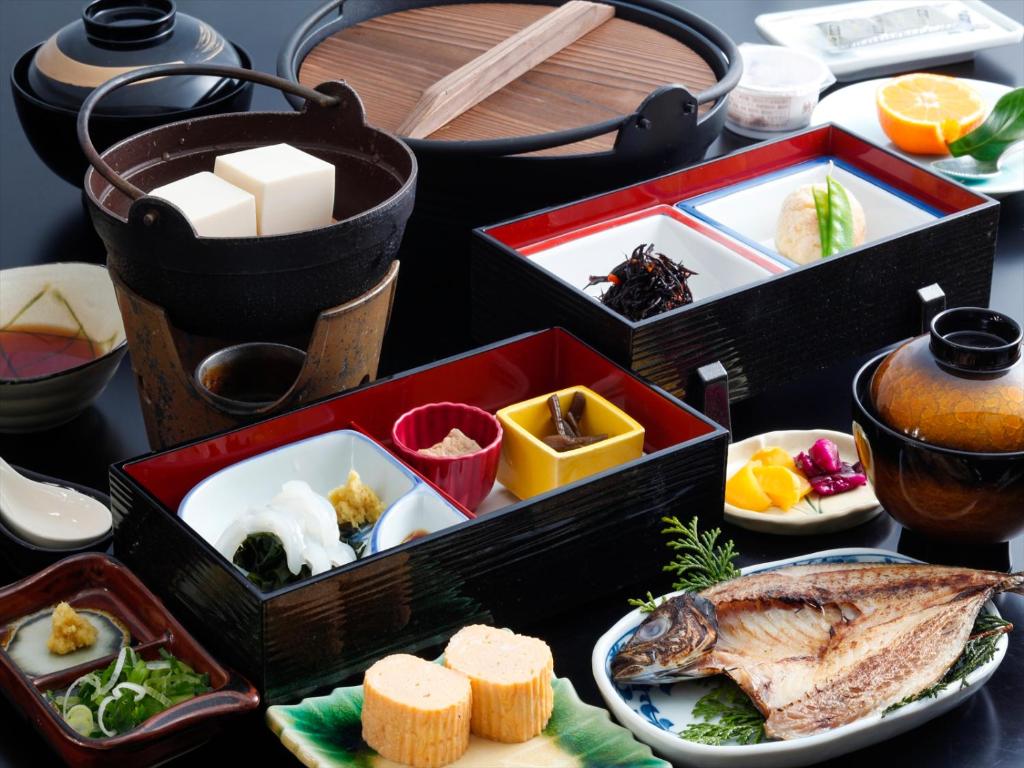 a table topped with boxes filled with different types of food at Bekkan Yosanoso in Miyazu