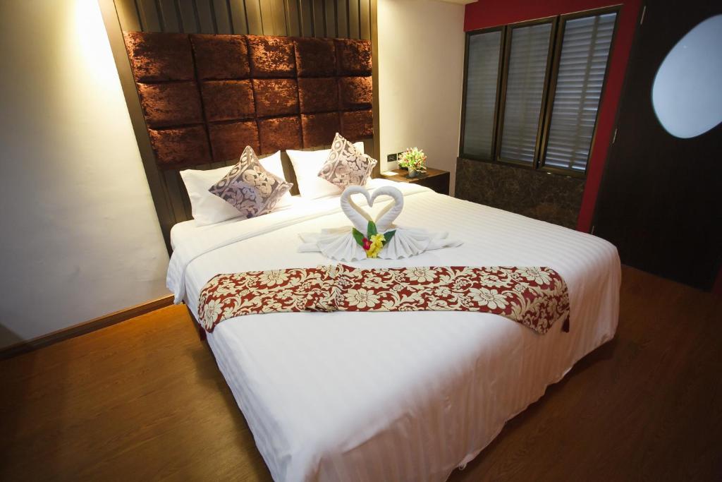 Säng eller sängar i ett rum på Grand Pink Hotel Hatyai