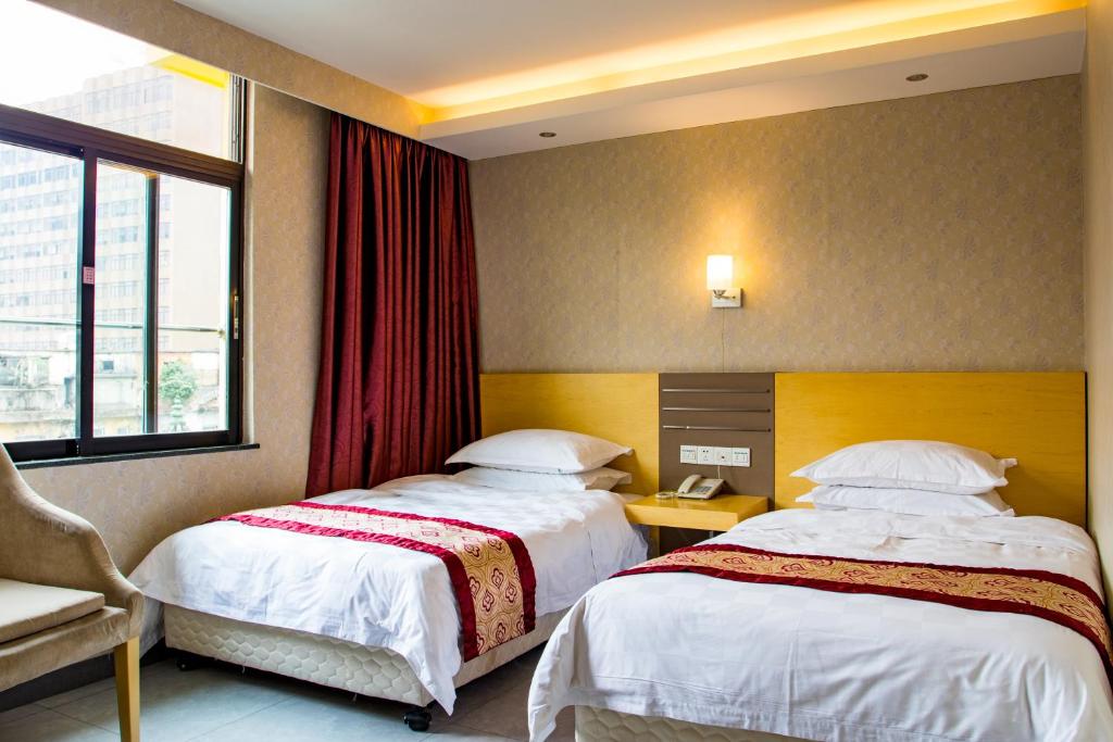 Postel nebo postele na pokoji v ubytování Guang Dong Hotel