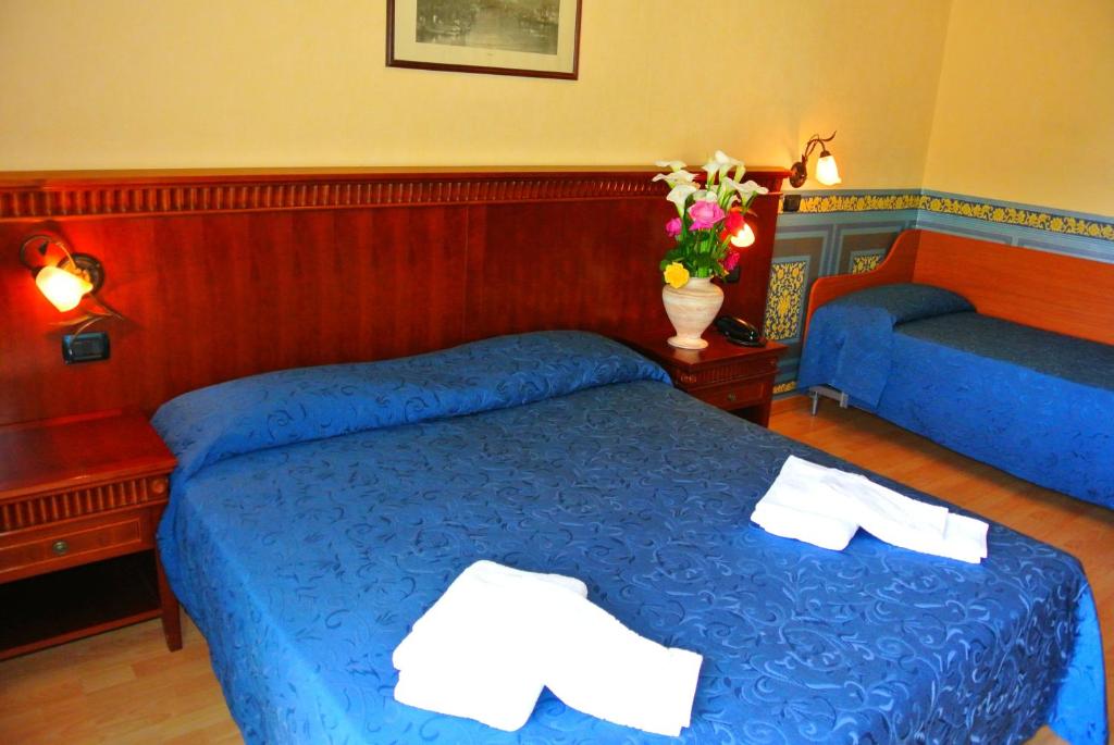 Postel nebo postele na pokoji v ubytování Hotel Mirage