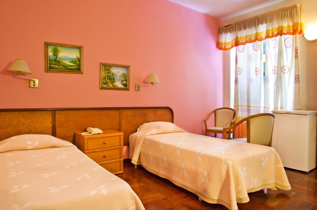 Postel nebo postele na pokoji v ubytování Residencial Colombo