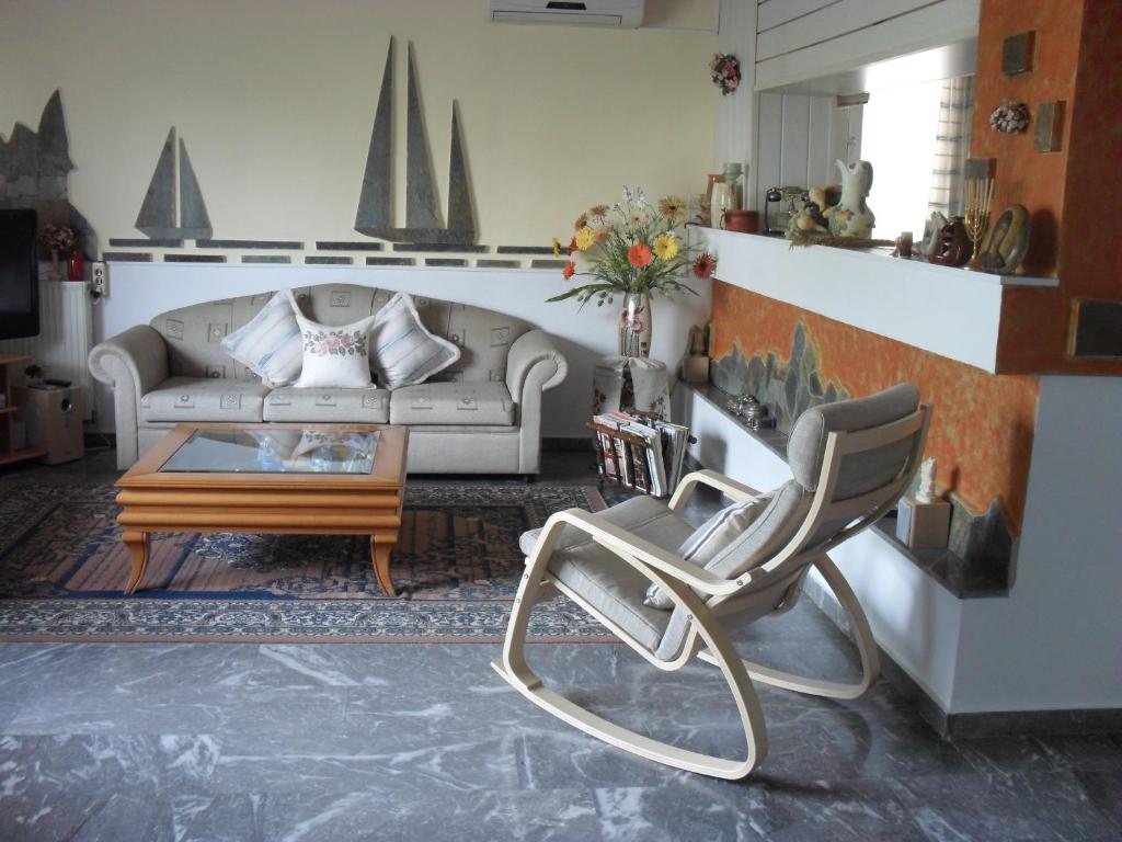 a living room with a couch and a coffee table at La Santre Villa in Amoudara Herakliou