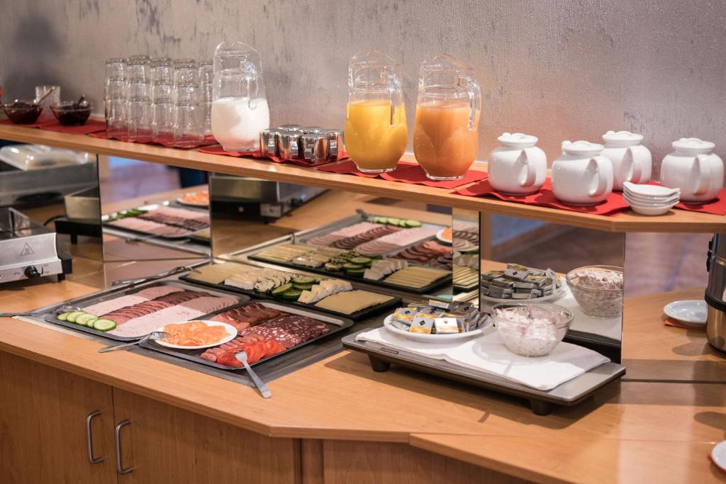 a buffet line with sushi and other foods and drinks at Hotel Zur Sonne in Waren