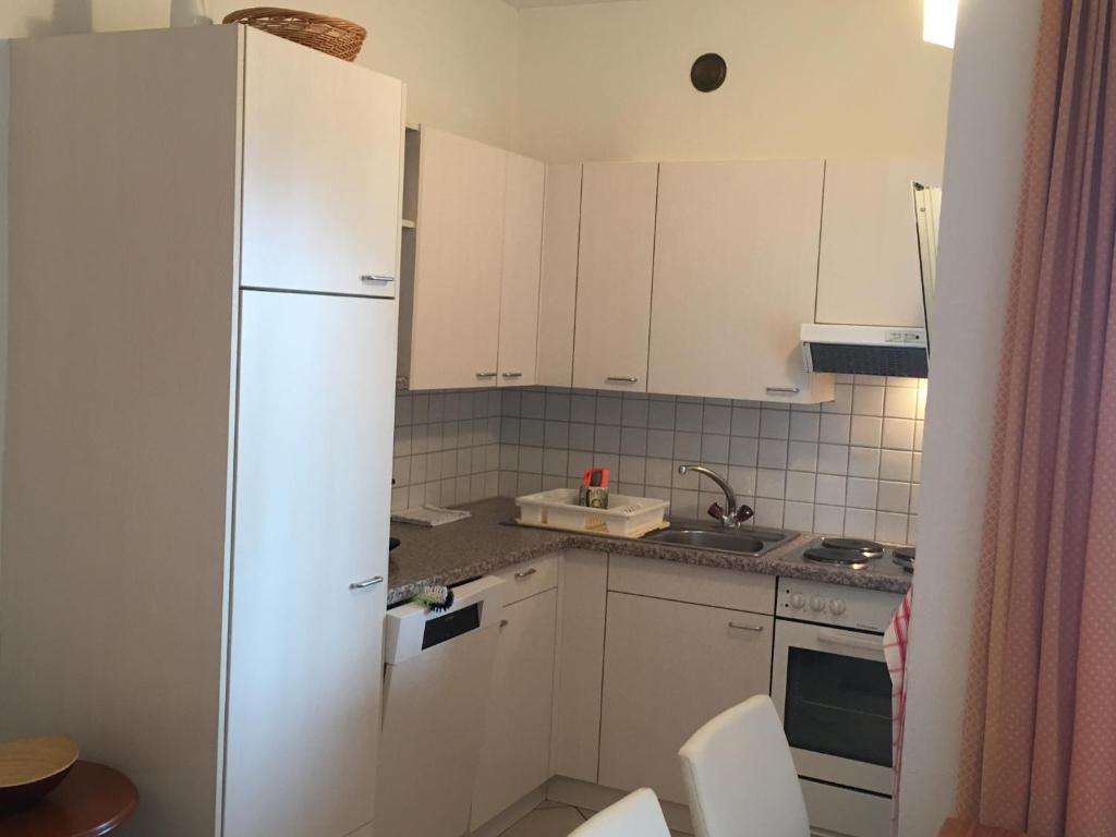 Kuchyň nebo kuchyňský kout v ubytování Apartments Posta al Lago
